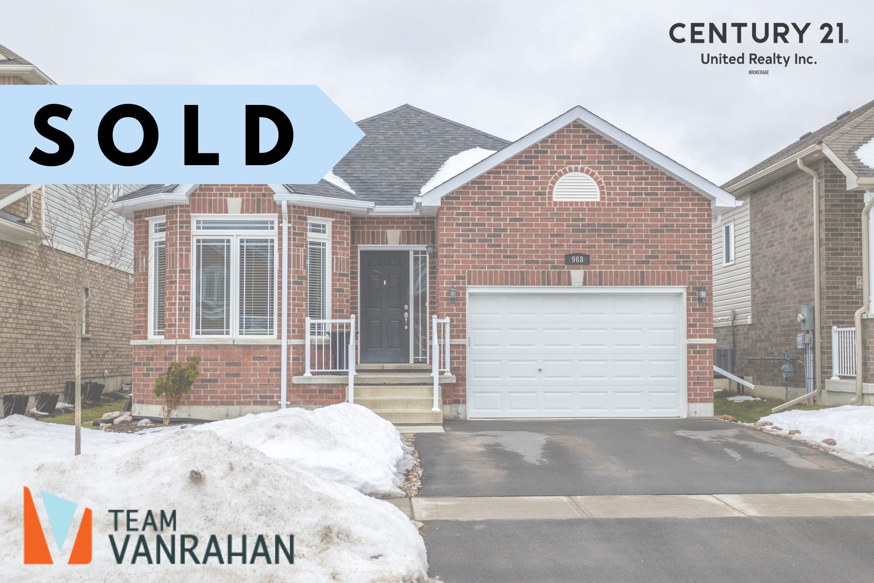 A newer brick bungalow with an attached garage and a bay window out front. SOLD text on top